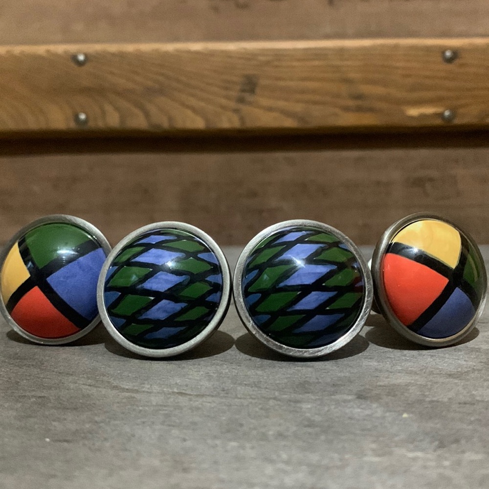 4 metal and painted or glazed ceramic knob drawer pulls very 80’s to me